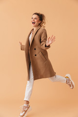 Photo of delighted attractive woman smiling and jumping