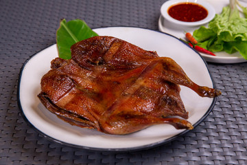 South East and East Asia: Typical Asian Food, Grilled whole duck served on the white plate
