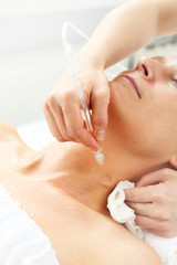 Oxygen oxybrasion. Smooth neck and cleavage The beautician performs oxygen oxybrasion treatment on the skin of the neckline and neck of a woman. Care treatment, skin cleansing