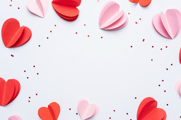 Paper elements in shape of hearts on white background. Symbols of love for Happy Women's, Mother's,...