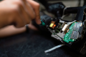 Male broadcast engineer maintains camera equipment