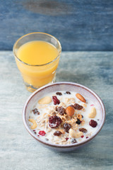 Tasty and healthy breakfast with granola and fresh orange juice. Rustic wooden background. Copy space. 