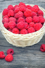  Vintage basket with raspberries. Red raspberries. Ripe berry in wicker basket. Raspberries in basket on the table.