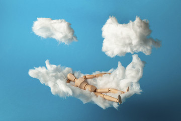 Toy man relax on cloud bed. Business freedom, keep calm.