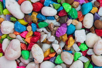 background of colorful, polished, semiprecious stone on grained wood