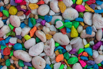 background of colorful, polished, semiprecious stone on grained wood