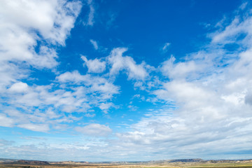 Spring sky with clouds above the badlands Bardenas Reales in the southeast of Navarre