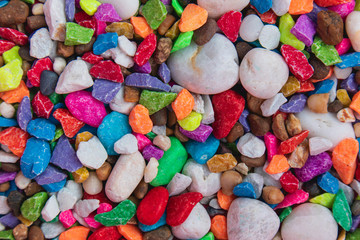 background of colorful, polished, semiprecious stone on grained wood