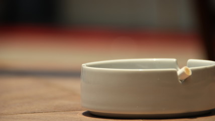 cigarette ashtray on the table, in a photo with a blurry background and selective focus