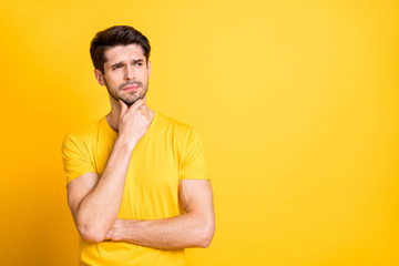 Portrait of his he nice attractive discontent doubtful brown-haired guy wearing tshirt thinking...