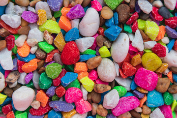 background of colorful, polished, semiprecious stone on grained wood