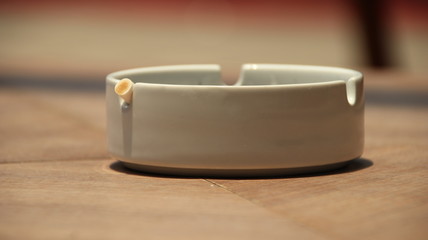 cigarette ashtray on the table, in a photo with a blurry background and selective focus