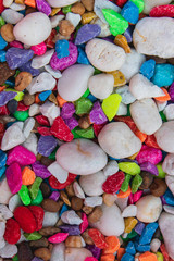 background of colorful, polished, semiprecious stone on grained wood