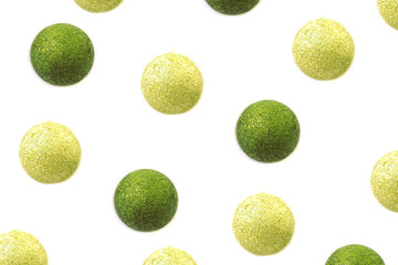 Shiny golden and green balls Christmas pattern isolated on white background. Top view festive background.