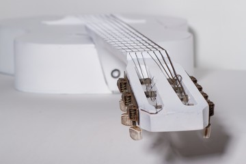 Musical instrument white guitar close-up on a white background