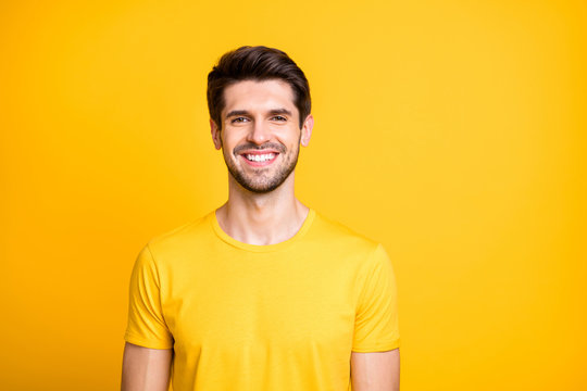 Close-up portrait of his he nice attractive cheerful cheery guy wearing tshirt smiling isolated over bright vivid shine vibrant yellow color background