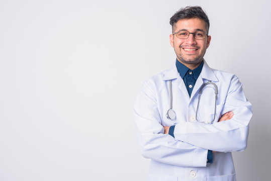 Portrait Of Happy Persian Man Doctor Smiling With Arms Crossed