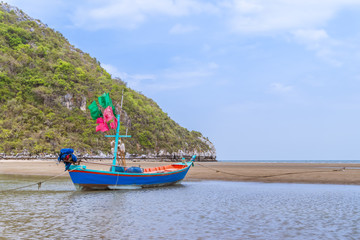 Naklejka na ściany i meble Fishing boat on beach near fisherman village at Khao Kalok mountain, near Hua Hin, Thailand