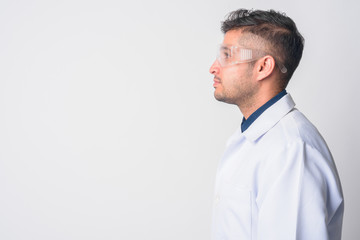 Closeup profile view of young Persian man doctor as scientist