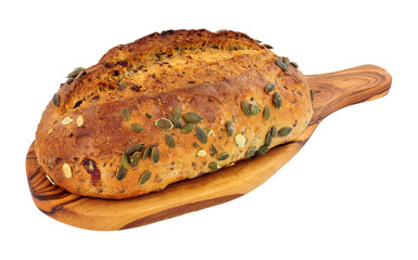 Stone baked pumpkin seed bread loaf on a wooden board isolated on a white background