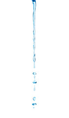narrow stream of water with drops on an isolated white background