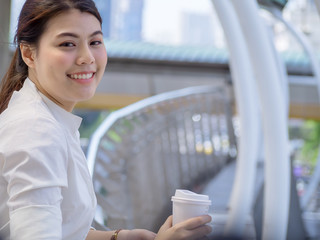 Close up portrait of a professional business woman smiling outdoor urban city downtown