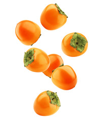Falling persimmon isolated on white background, clipping path, full depth of field