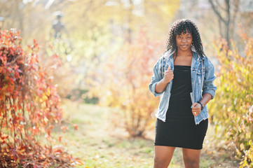 Stylish trendy afro france curly woman posed at autumn day in jeans jacket. Black african female...