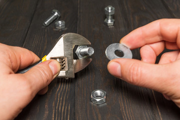Fototapeta premium The master tightens the nut with an adjustable wrench