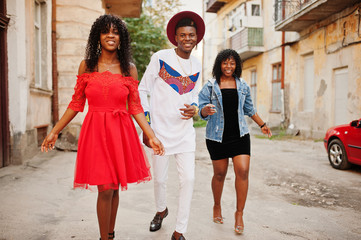 Group of three stylish trendy afro france friends posed at autumn day. Black african man model with two dark skinned womans.