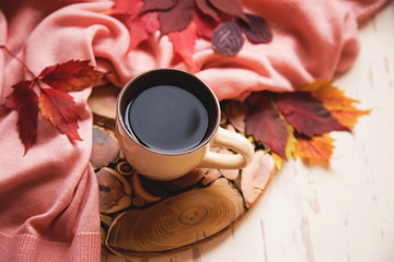 cup of black coffee and red autumn leaves