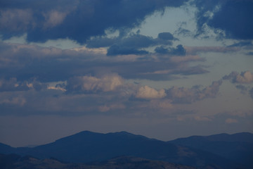 snow-capped peaks of the mountains. clouds walking in the evenings over the mountains