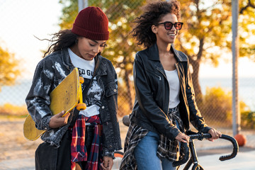 Two attractive young african girls standing at the sports ground