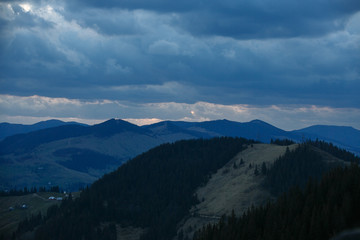 spring evening in the mountains with blue clouds