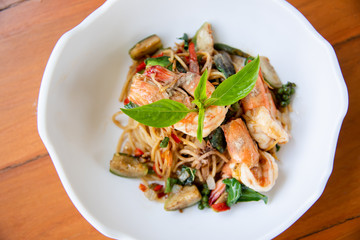 Spaghetti with spicy shrimp on white dish