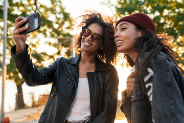 Two attractive smiling young african girls standing