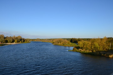 A beautiful view of the peaceful Narew river. Sunny, autumn day at the river Narew in polish countryside. River in western Belarus and north-eastern Poland, is a right tributary of the Vistula River. 