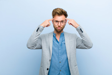 young businessman with a serious and concentrated look, brainstorming and thinking about a...