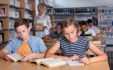 Modern teenage schoolers reading and writing