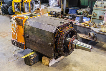 disassembled large electric motor in a repair shop
