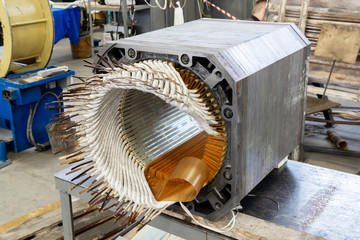 stator from a disassembled electric motor in a repair shop