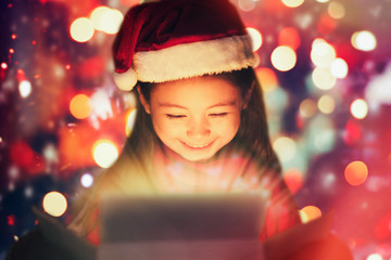 closeup smiling  little girl watching the christmas presents.