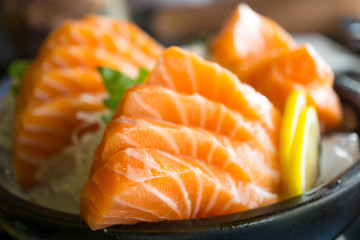 Salmon raw on a plate. Salmon sashimi.