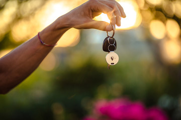 One person hand holding the car keys