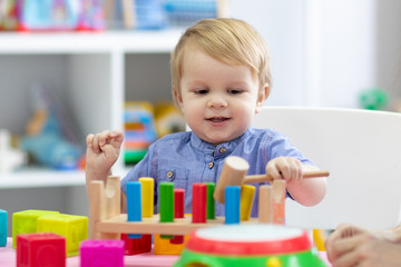 kid boy plays with educational toy at home or creche