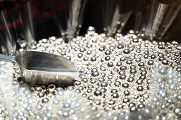 lot of silver sweets with a spatula