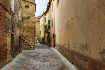Amazing view with a narrow picturesque medieval street of old town of Pienza in Tuscany, Italy