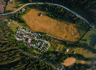 Top down aerial view of a camping site, recreation with a tent and parking for a motor home, camper...
