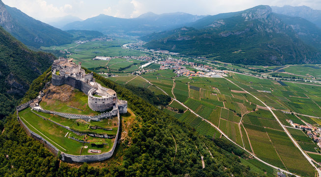 Aerial view of Beseno Castle and northern vineyards, the largest fortified structure in Besenello, Trento, Italy. wide panorama with high resolution, touristic place in Europe
