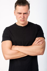 Closeup portrait. Young angry man looking at camera. Human emotion and negative feelings. Studio shot on white background